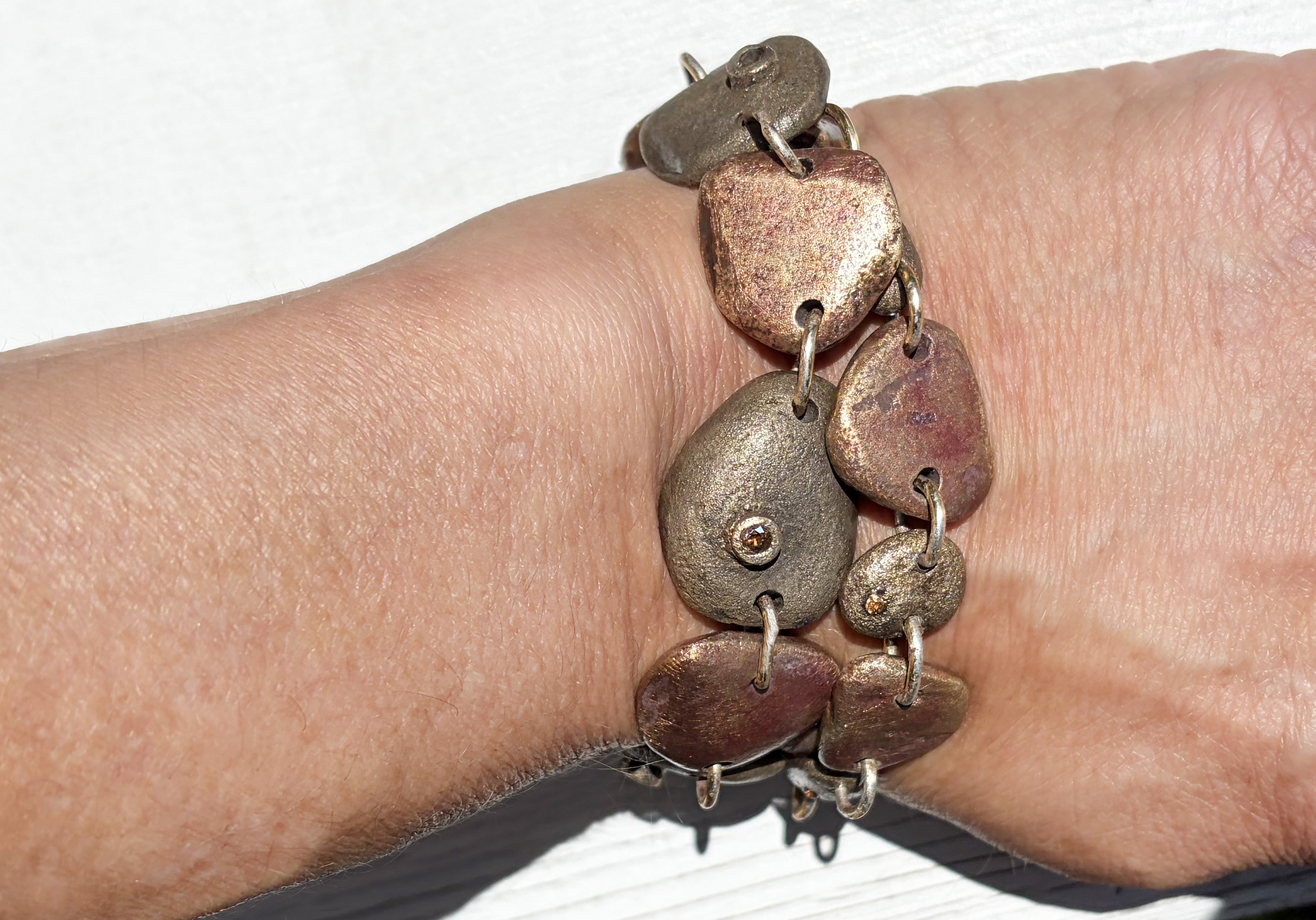 Yellow and white bronze heat-toned river stone bracelet with gems