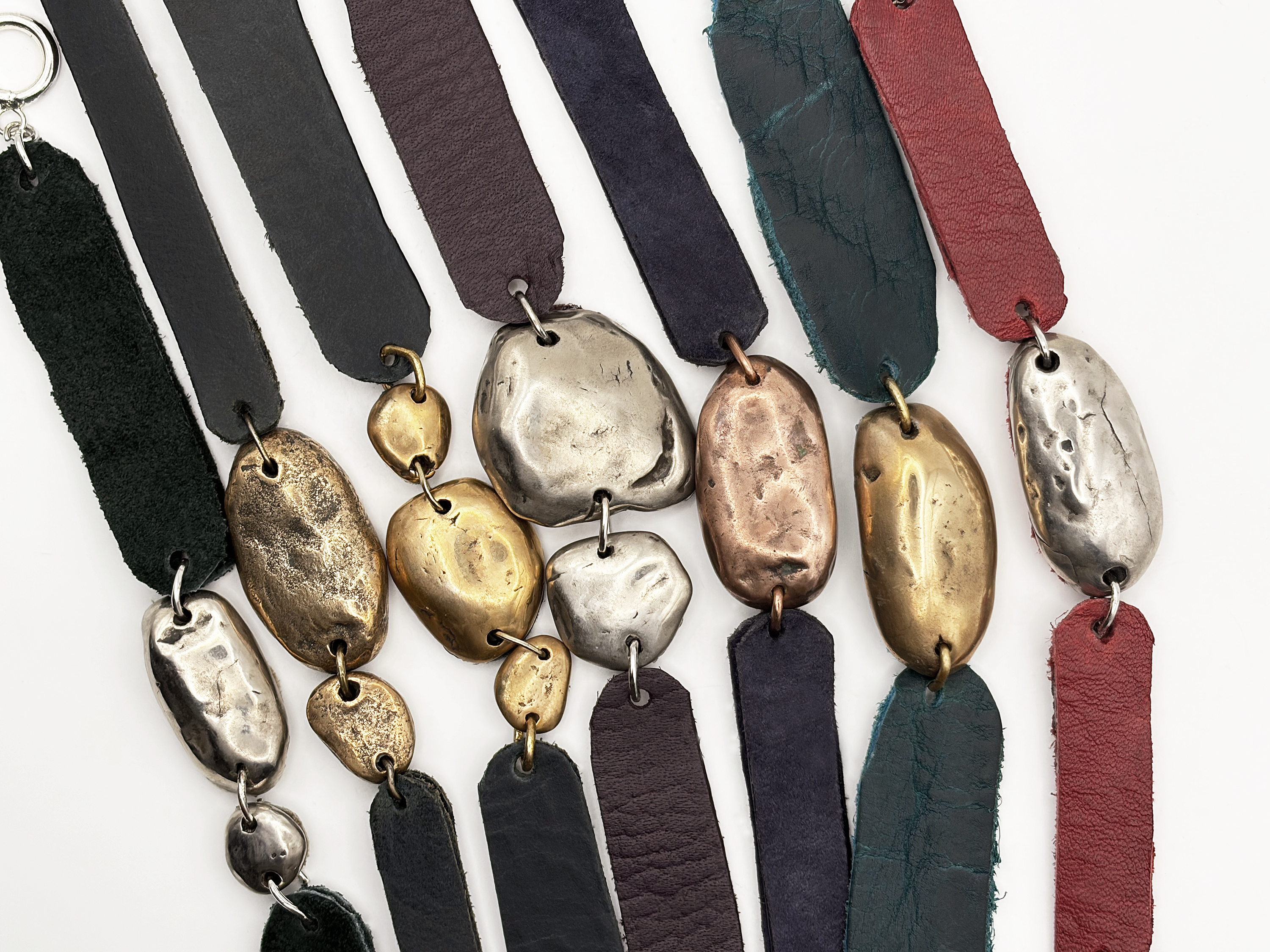 Copper, white and yellow bronze tumbled river rock bracelets on leather